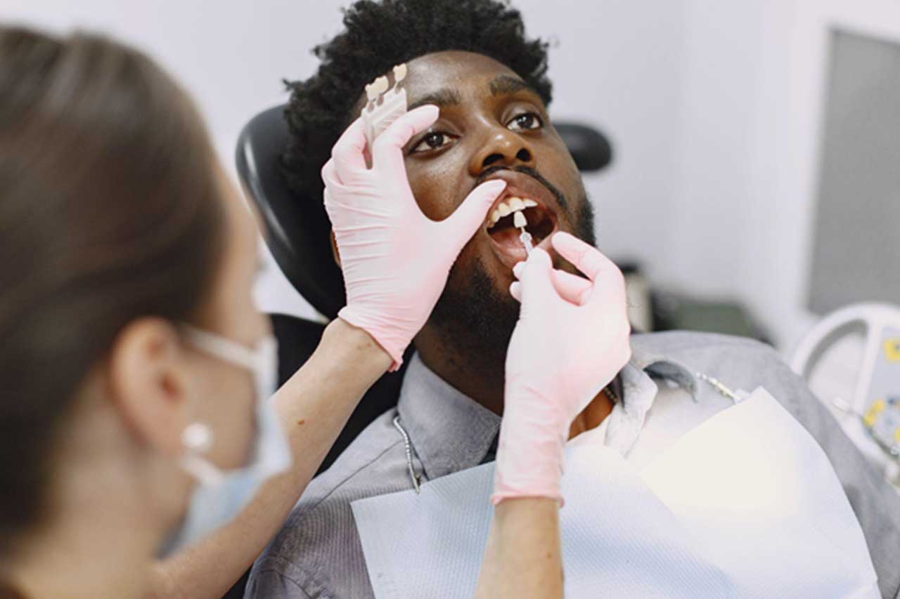 Dentist matching crown shade for patient