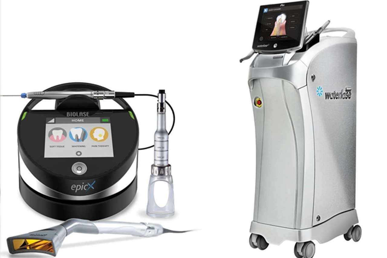 Dentist performing laser dental treatment on patient